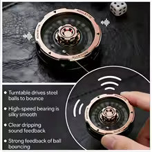 A close-up product photo of a round metallic ball-bouncing toy with a rose-gold/copper-toned rim and dark center, shown on a dark textured surface. The image includes marketing text callouts and a circular inset showing a finger pressing the toy, which causes the balls to bounce.

